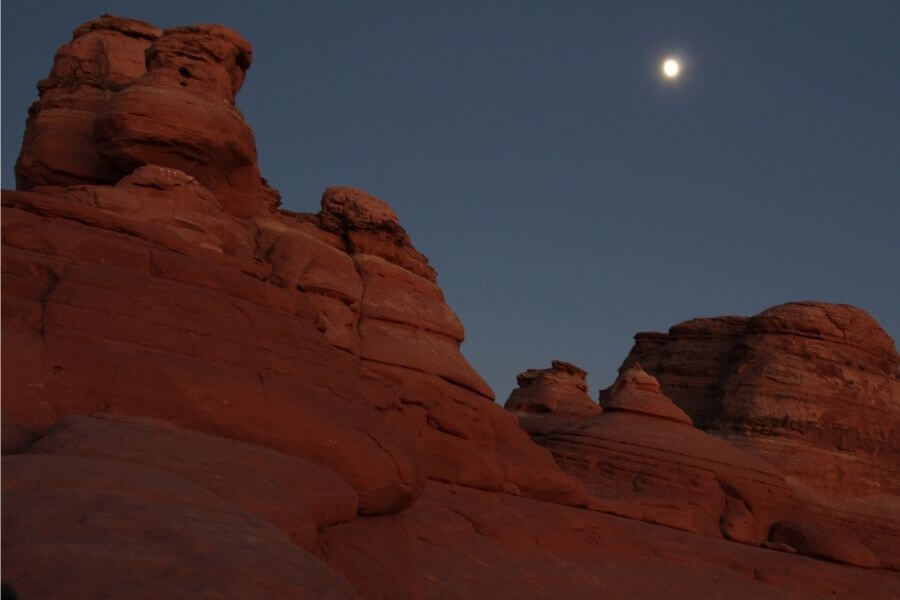 moon over rock formations